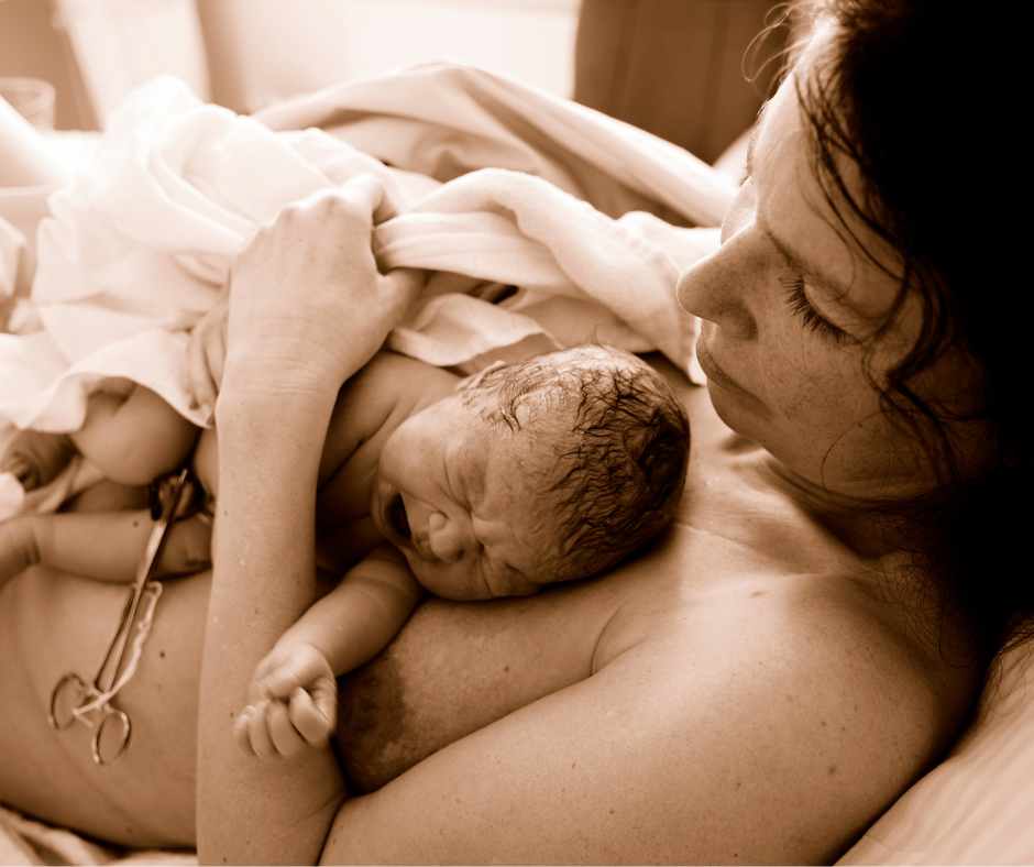 Newborn lays on top of mum, having skin to skin contact, straight after birth. Mum looks on, concerned about the impact of postnatal anxiety.