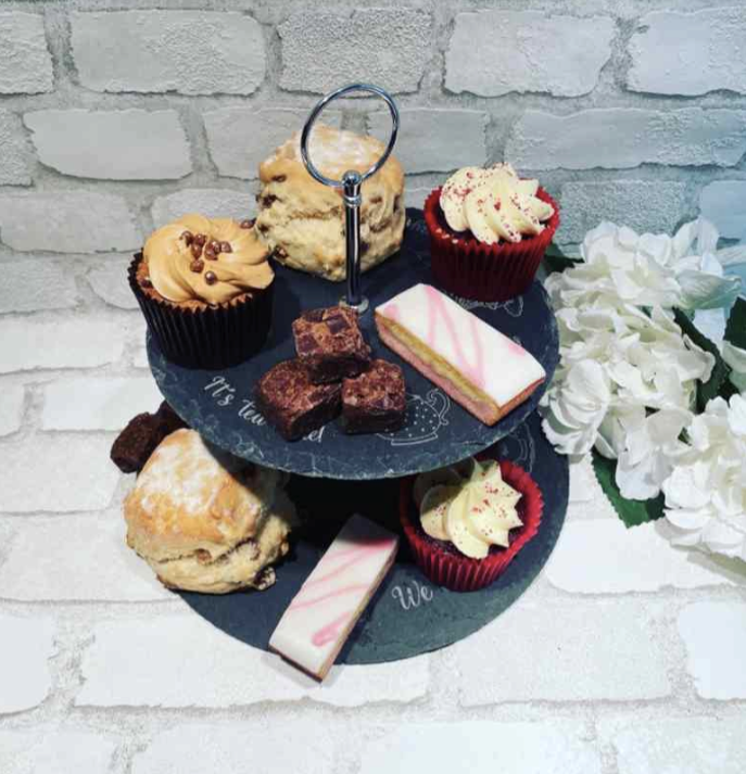 Afternoon tea stand with cakes covering a personalised message