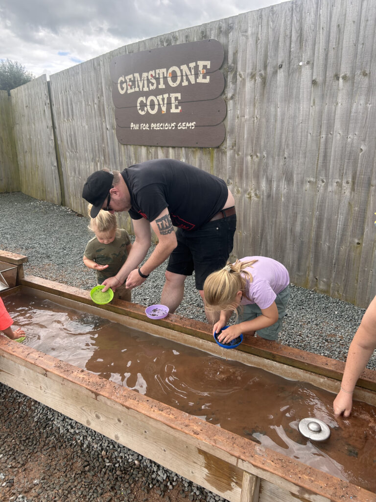 Children are panning for gems at Gemstone Cove at The Ice Cream Farm Cheshire